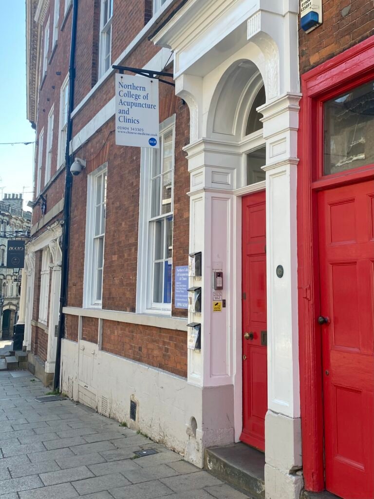 Image shows the front door of the NCA which is painted red