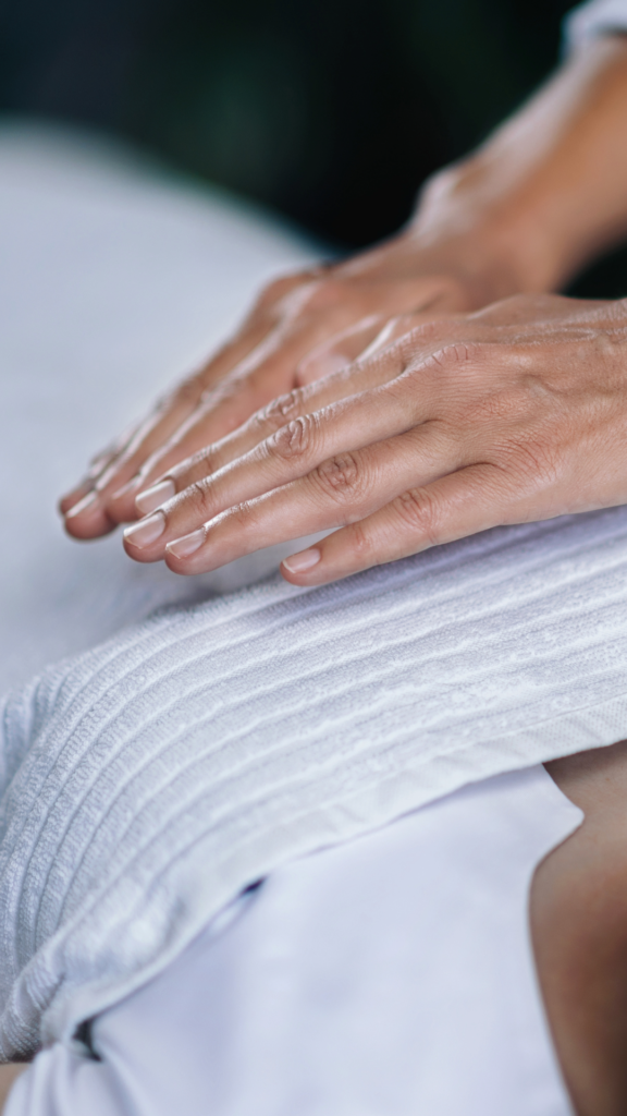 Reiki master hovering hands over heart chakra