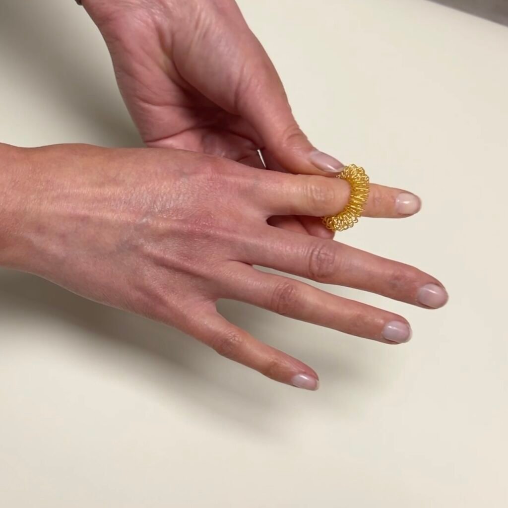 Acupressure ring being used on index finger