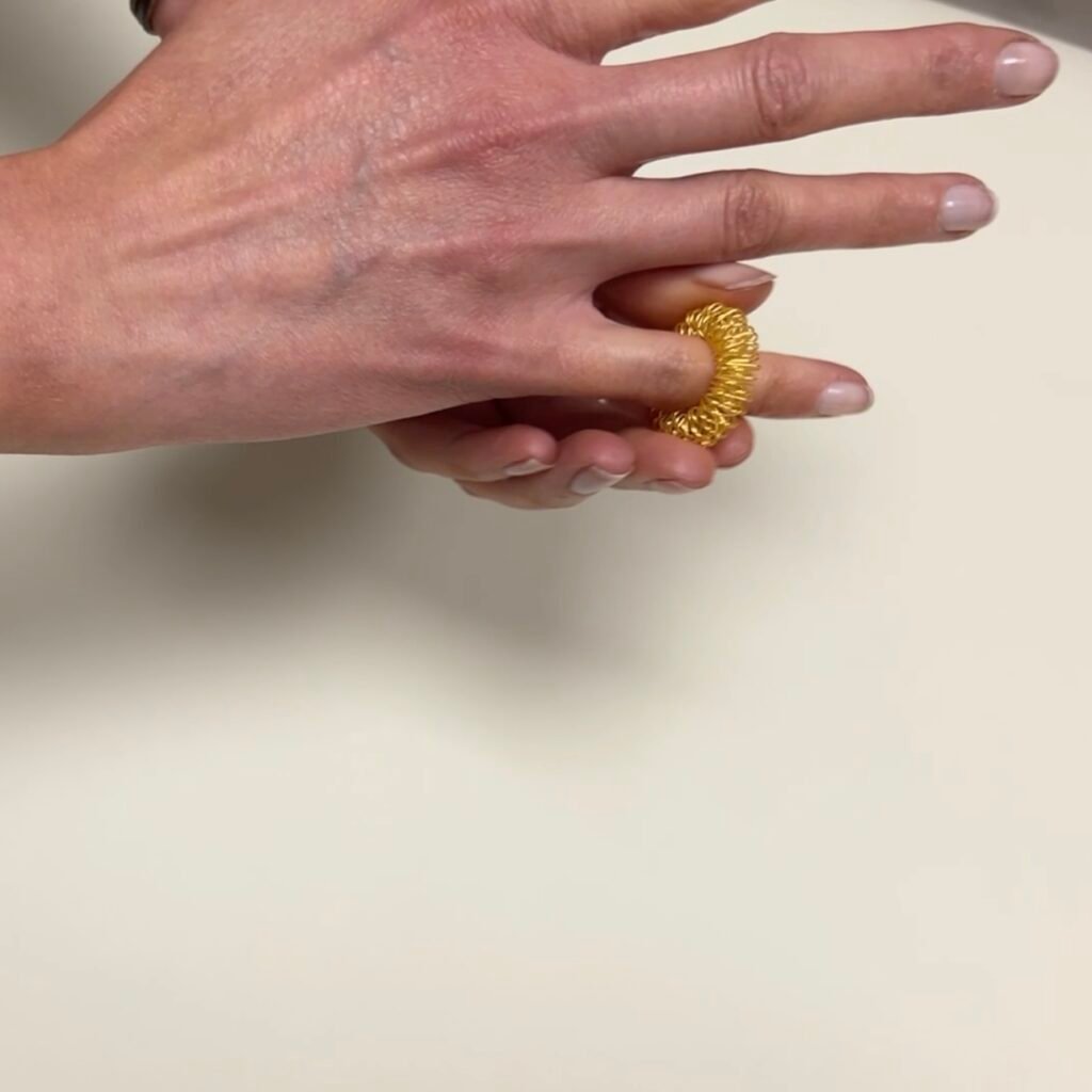 Acupressure ring being used on little finger