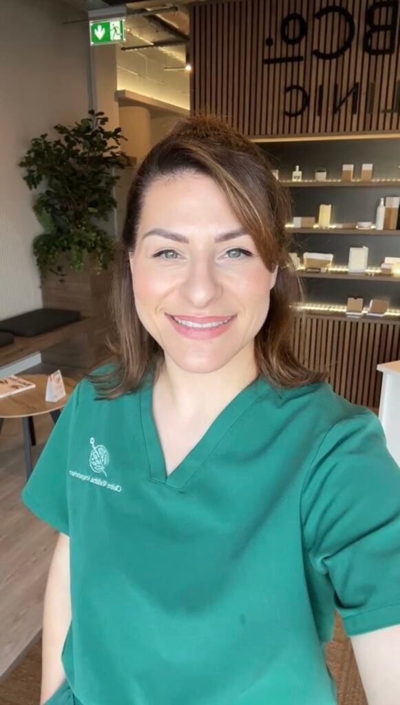 Smiling photo of a woman in green scrubs